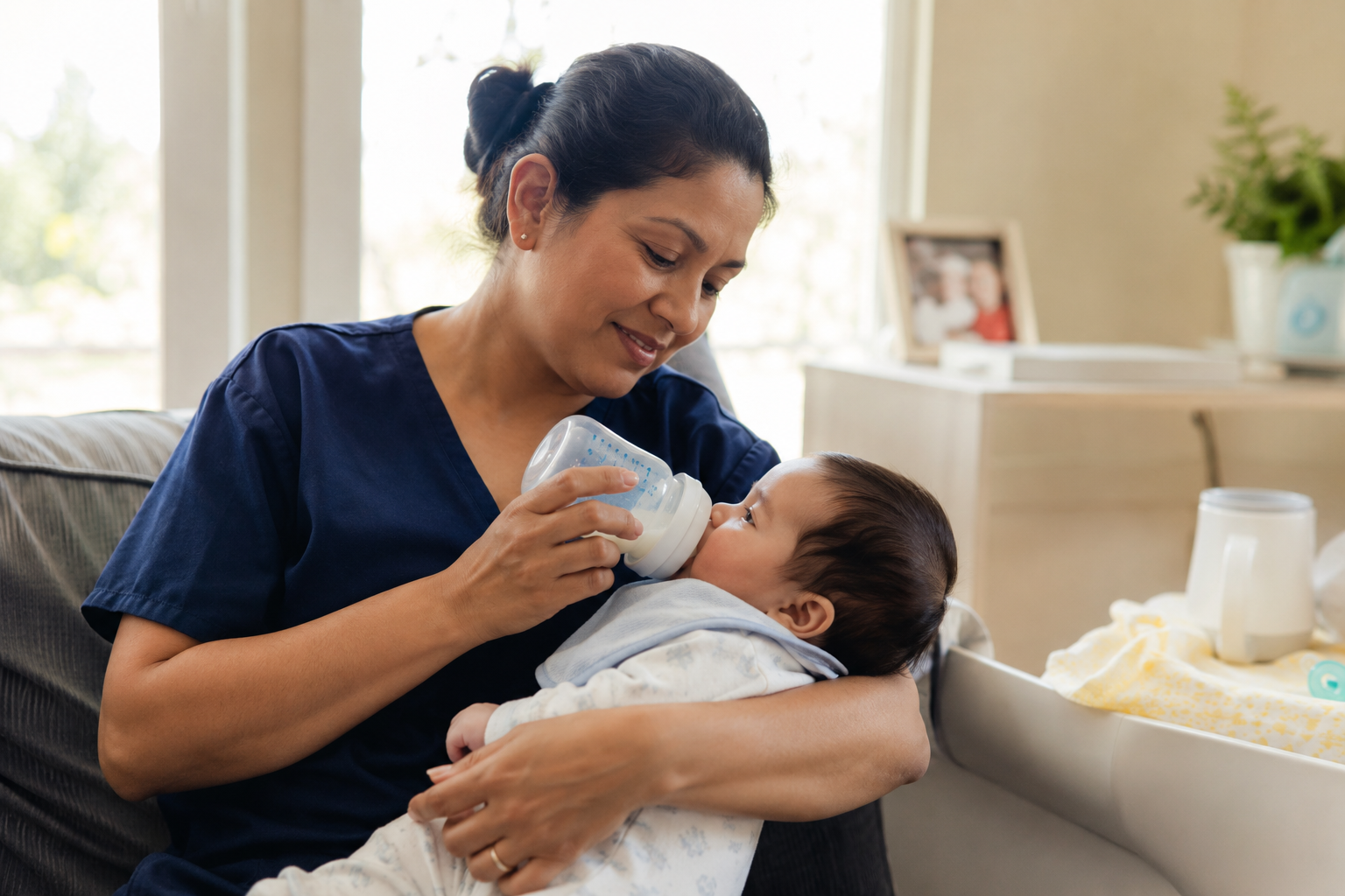 Nurse bottle-feeding a newborn baby
